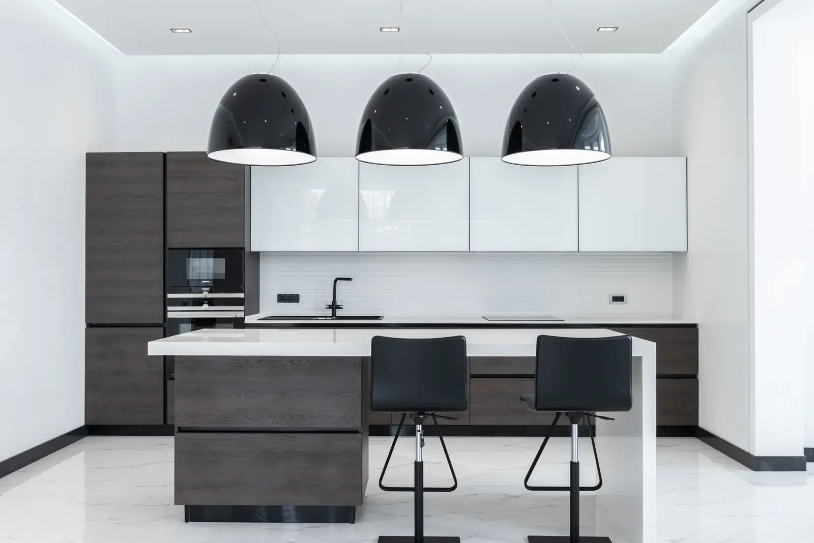 Cocina integral blanca con isla y cubierta de piedra
